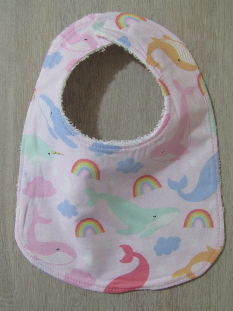 Flat baby bib-Coloured whales and rainbows